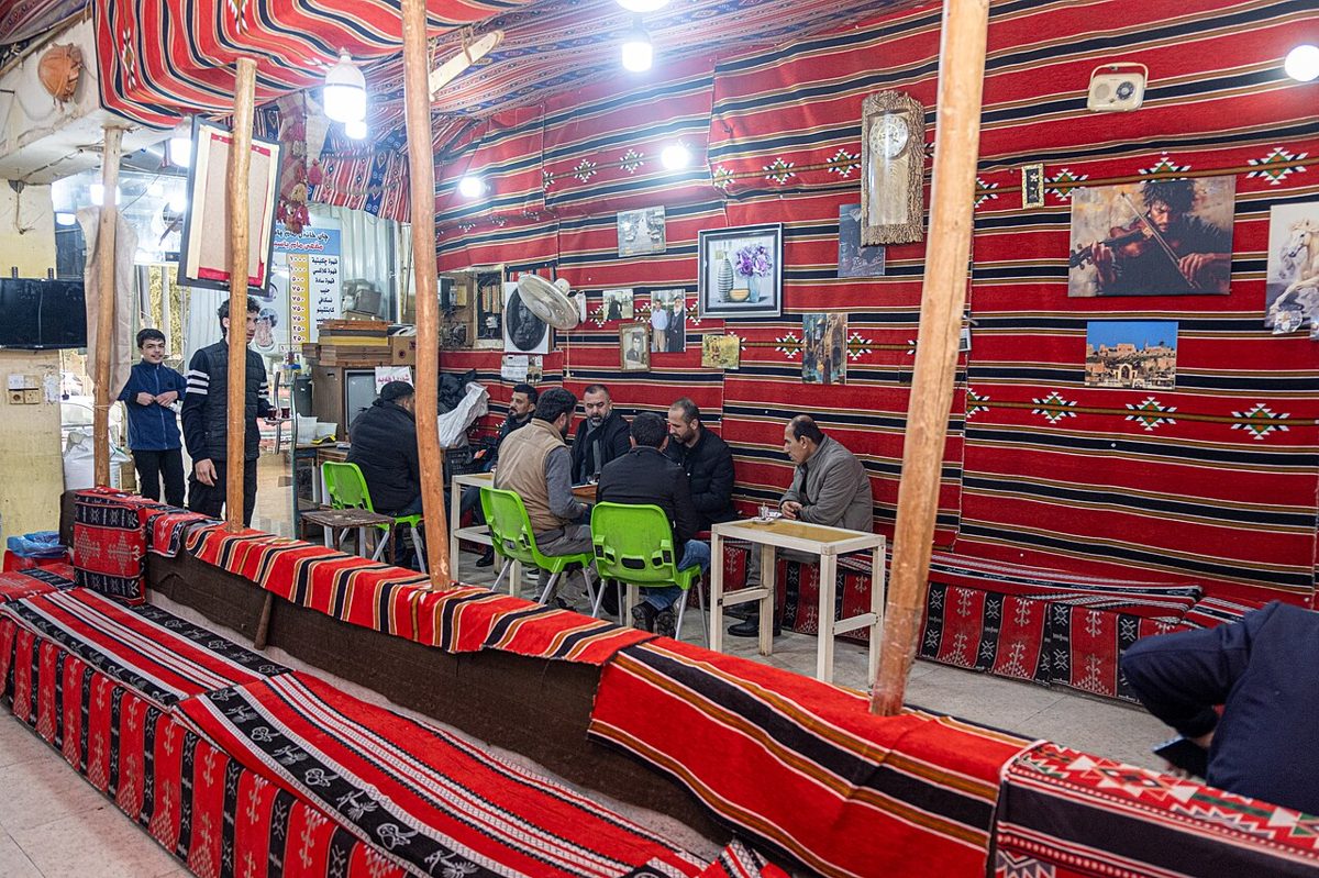 Men drinking tea in a traditional Iraqi chai khana, the social heart of Iraqi culture