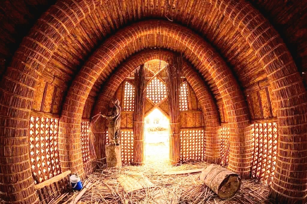 The arched reed interior of a traditional mudhif guesthouse in the southern Iraqi marshes