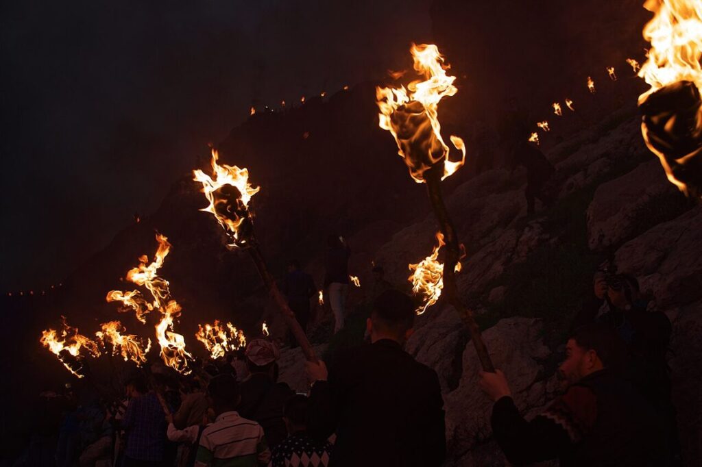Kurds carrying flaming torches up the mountain at Akre for Newroz