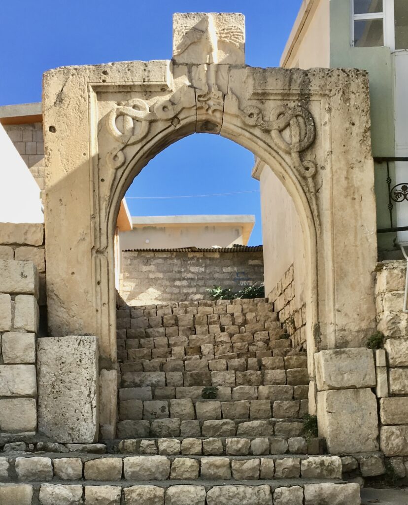 The carved stone arch of the Bahdinan Gate at Amedi above worn stone steps