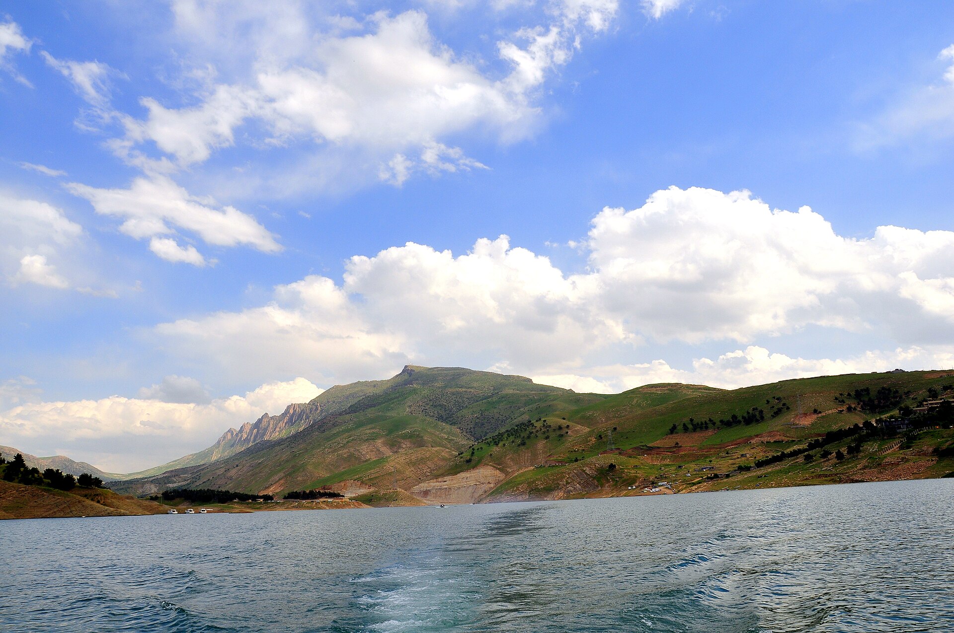 Dukan Lake in Sulaymaniyah Governorate, with green ridges rising behind open water