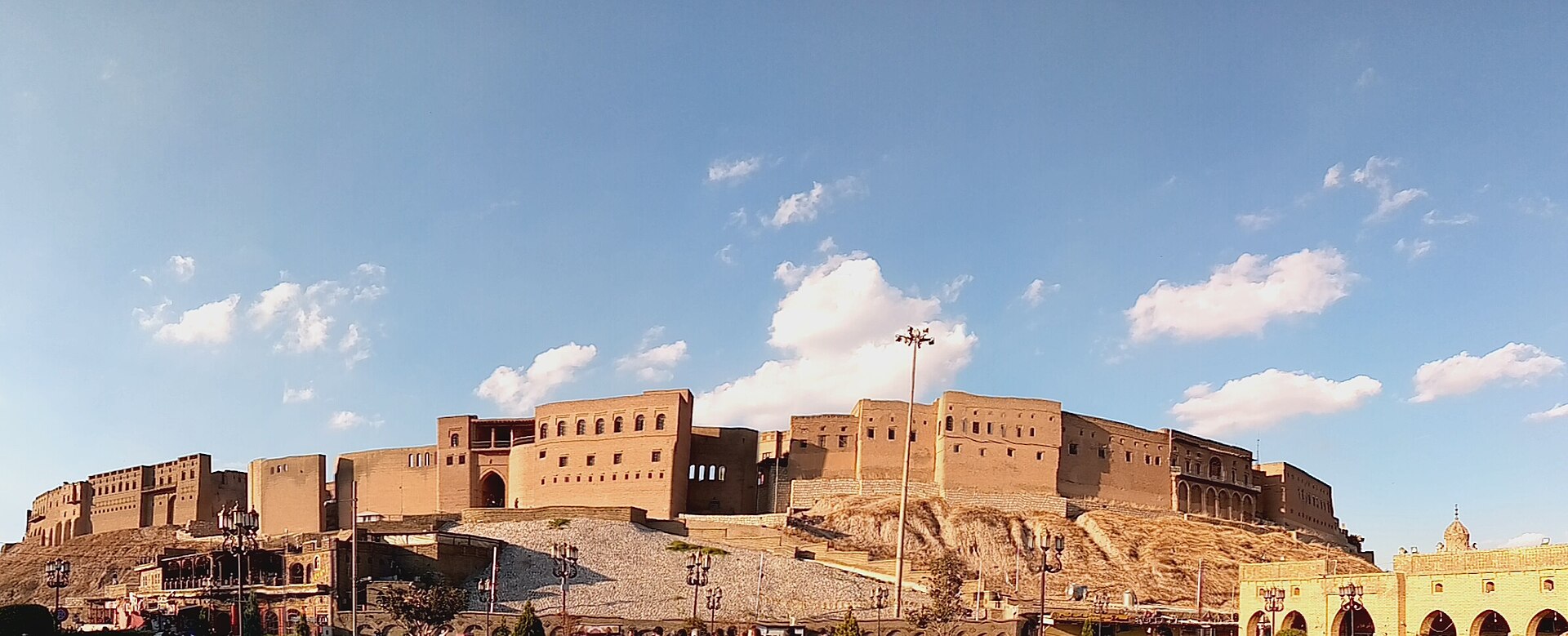 The mudbrick mass of Erbil Citadel rising above the modern city in the Kurdistan Region of Iraq