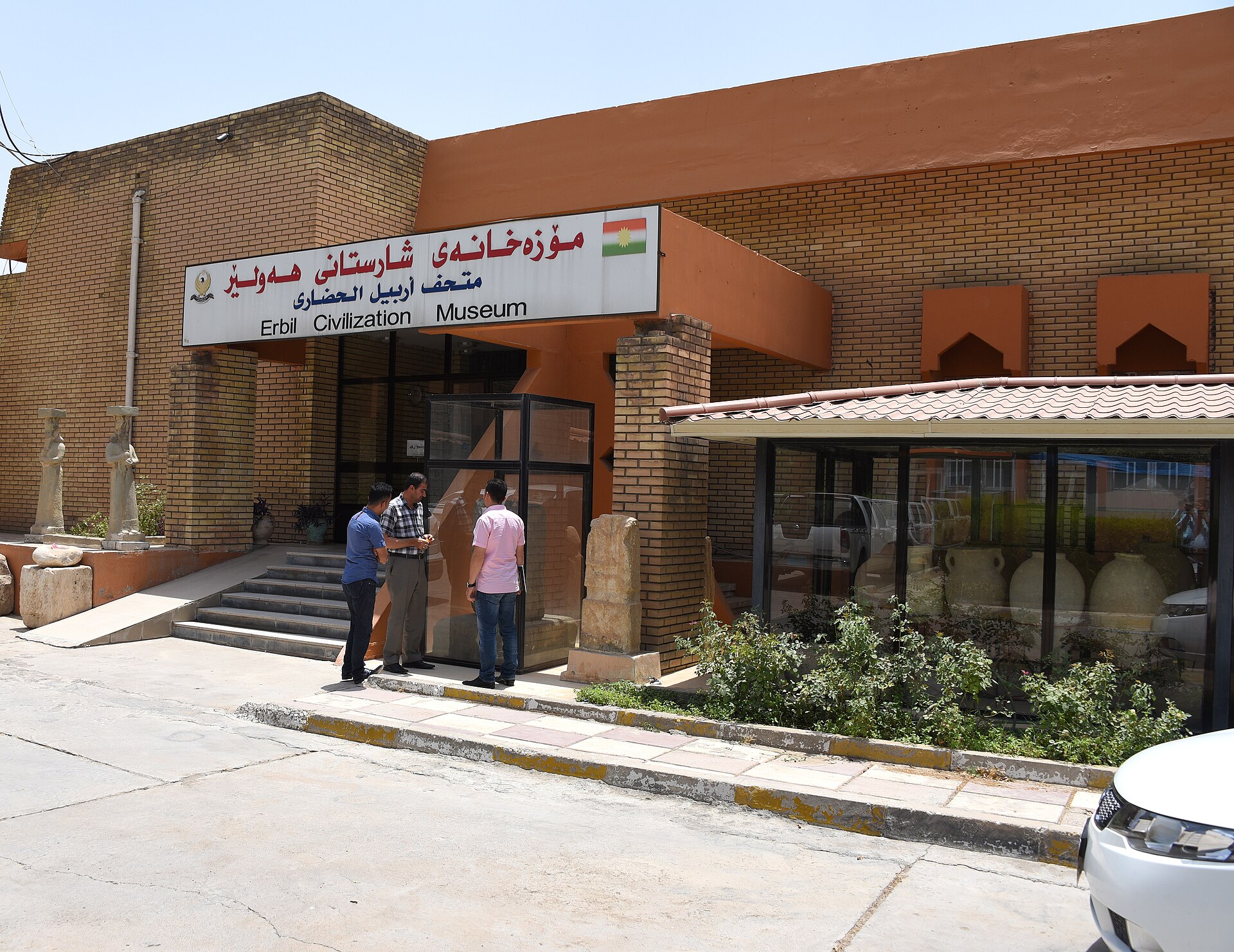 The low brick entrance of the Erbil Civilization Museum with its trilingual Kurdish, Arabic and English sign