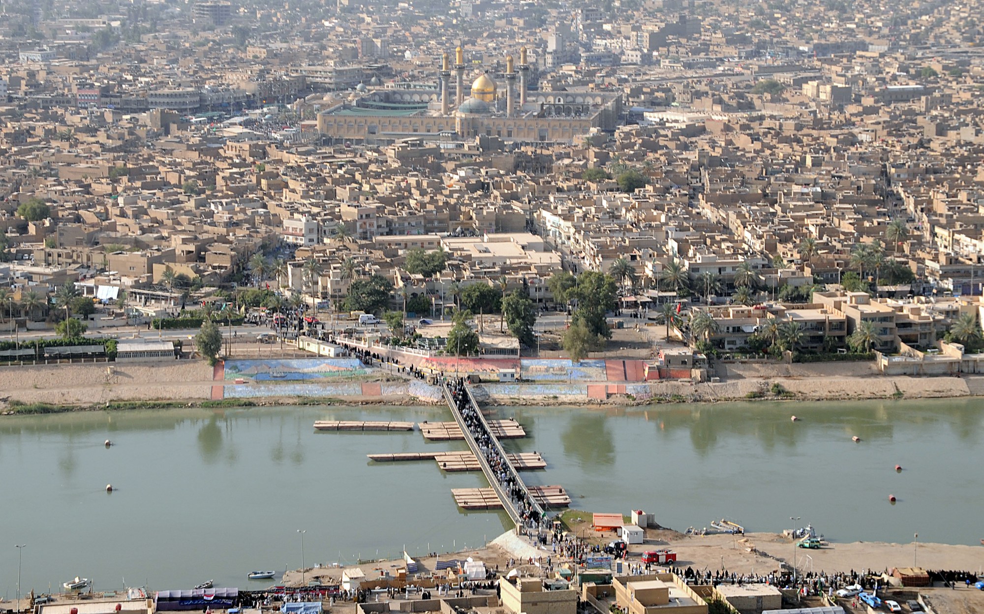 Aerial view of pilgrims crossing a pontoon bridge over the Tigris towards the gold-domed Kadhimiya shrine in 2008