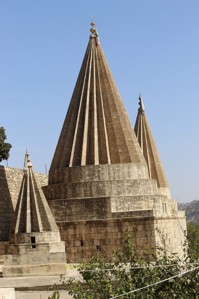 Fluted conical spires of the Yazidi temple at Lalish above the valley