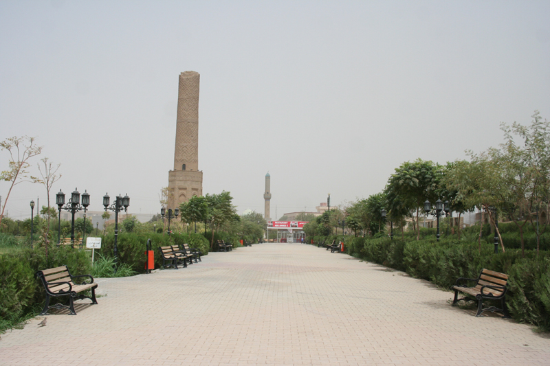 The brick Mudhafaria (Choli) Minaret rising above the benches and paths of Minare Park in Erbil