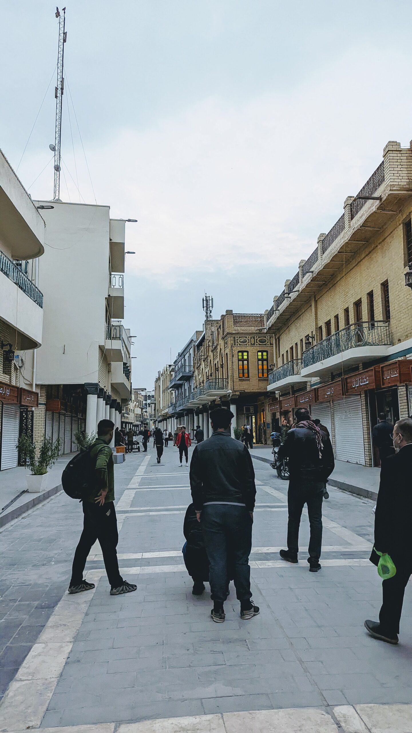 Pedestrians walking down the repaved, car-free Mutanabbi Street in Baghdad in December 2021