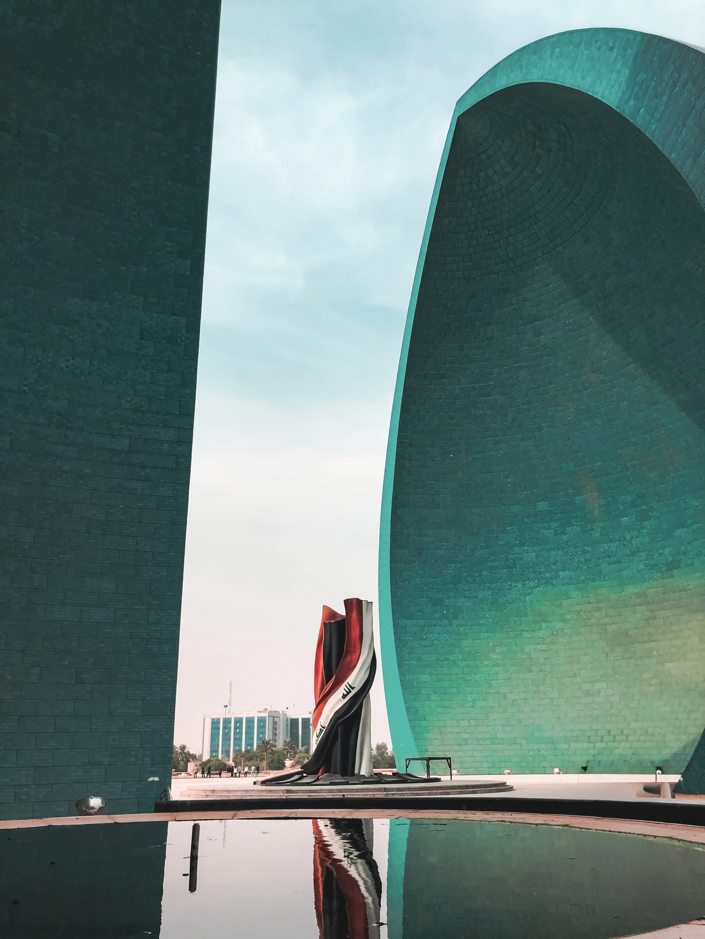 The bronze and acrylic Iraqi flag sculpture standing in the seven-metre gap between the two halves of the Al-Shaheed Monument dome