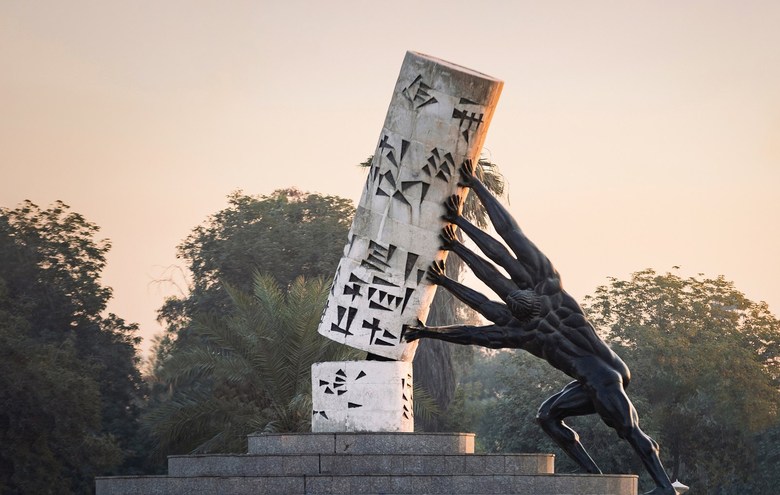 Mohammed Ghani Hikmat's Save Iraqi Culture sculpture, a broken Sumerian cylinder seal held up by bronze figures, in al-Mansour, Baghdad