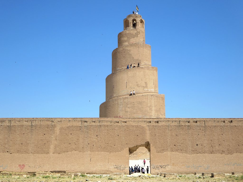 The spiral Malwiya minaret at Samarra with visitors walking up the external ramp
