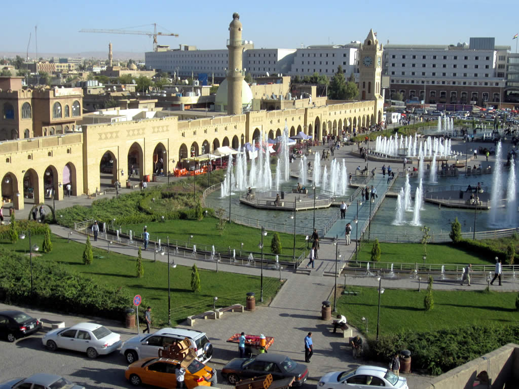 Fountains, lawns and the arcaded bazaar frontage of Shar Park below the citadel in Erbil