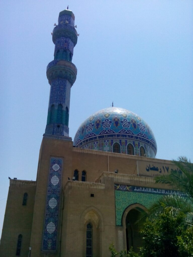 The blue-tiled dome and minaret of the 17 Ramadan Mosque beside Firdos Square in Baghdad