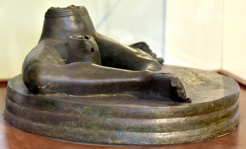 The copper Bassetki statue, the lower body of a seated figure on a round base inscribed with the name of Naram-Sin