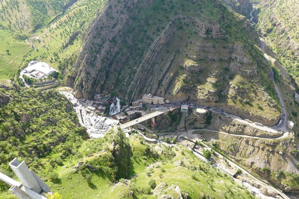Bekhal waterfall below a road bridge in a green valley near Rawanduz