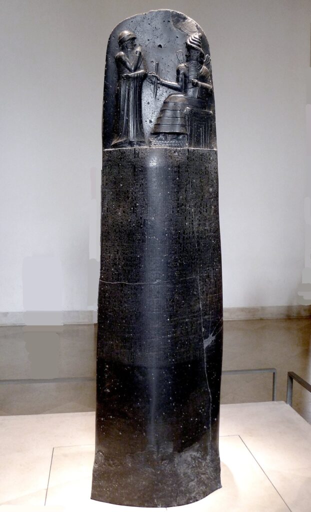 The black basalt stele of the Code of Hammurabi in the Louvre, with the king before the god Shamash carved at the top