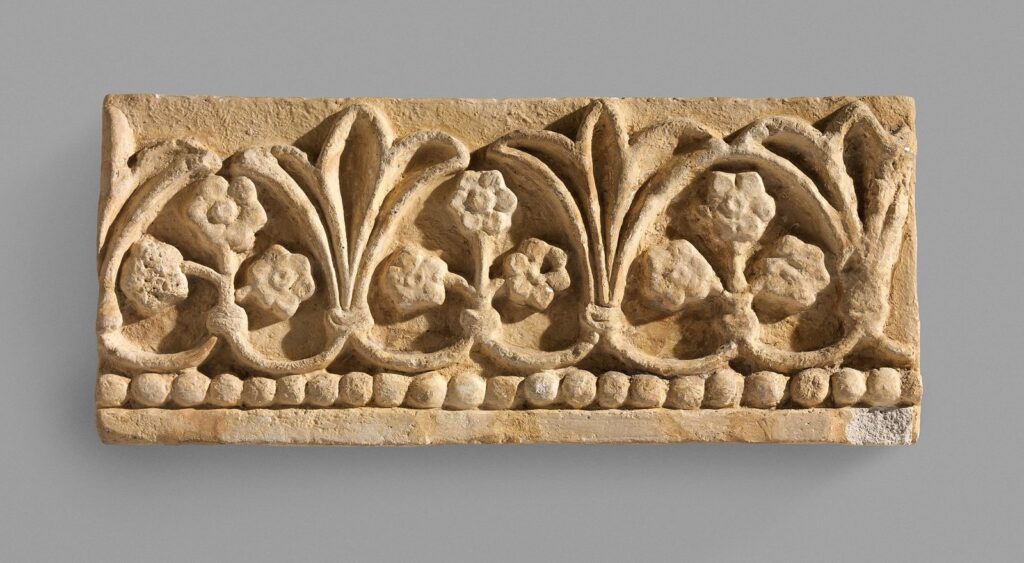 Carved Sasanian stucco panel from Ctesiphon with a frieze of palmettes and rosettes
