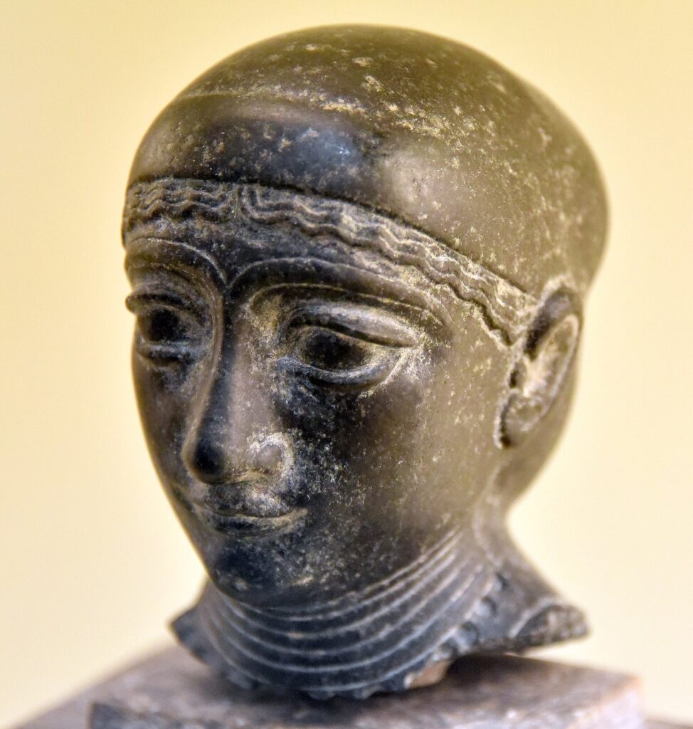 Polished diorite head of a woman with a headband, probably from Girsu, from the reign of Gudea