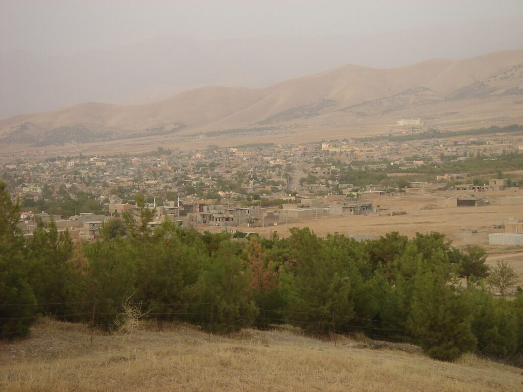 The town of Halabja spread across the plain below bare hills