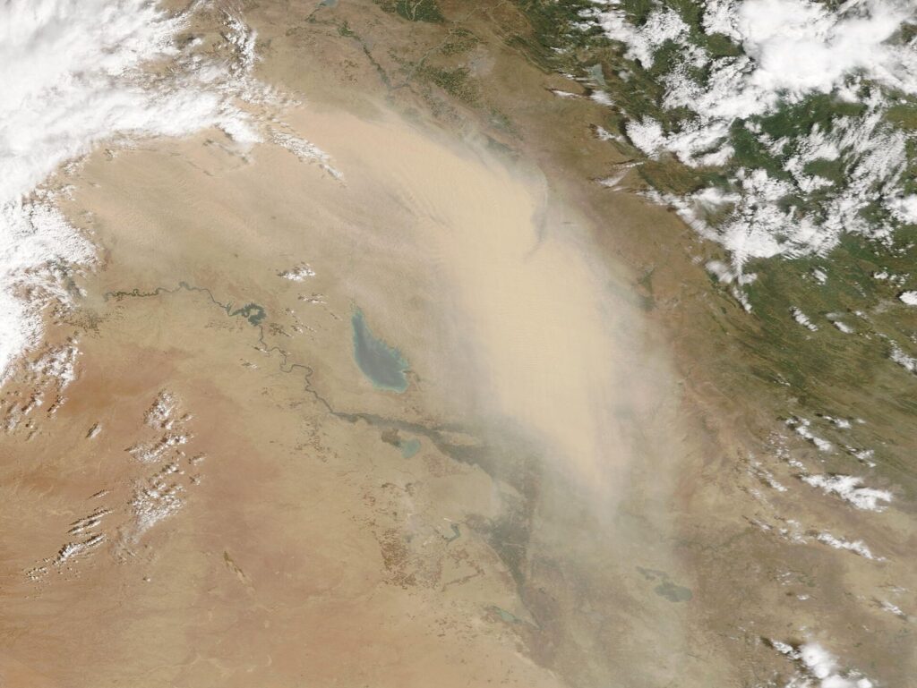 Satellite image of a dust storm spreading across Iraq, the kind of hazard that shapes Iraq weather by month in spring