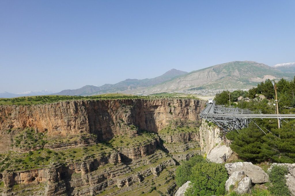 The deep Rawanduz canyon with layered rock walls and a steel viewing platform, a highlight of this Iraq itinerary for 2 weeks