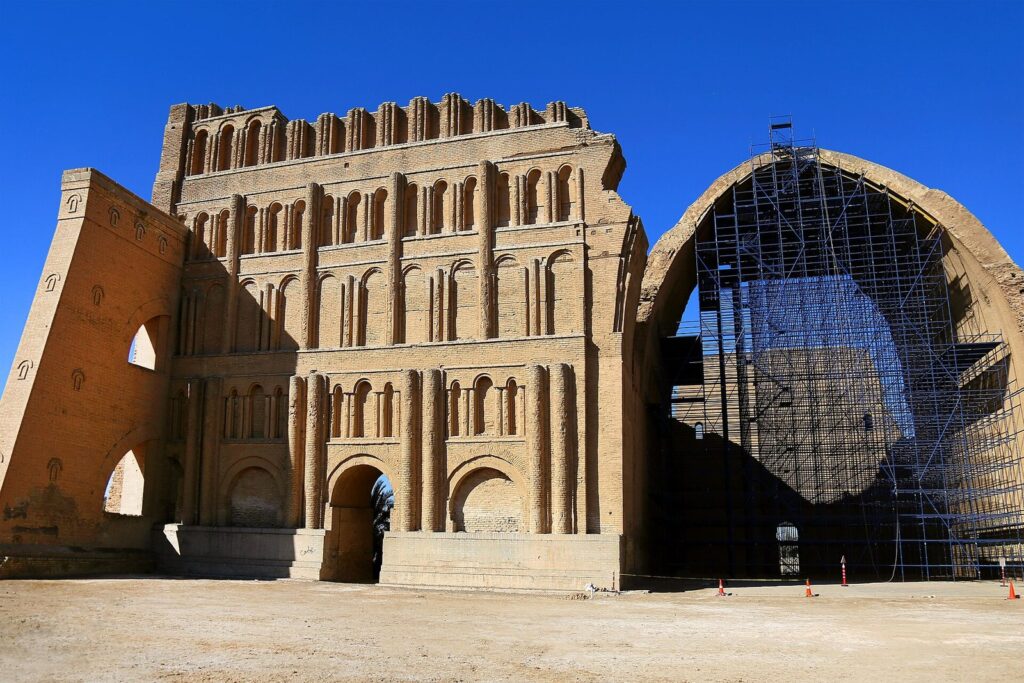 The brick facade of the Taq Kasra at Ctesiphon with its great arch encased in restoration scaffolding
