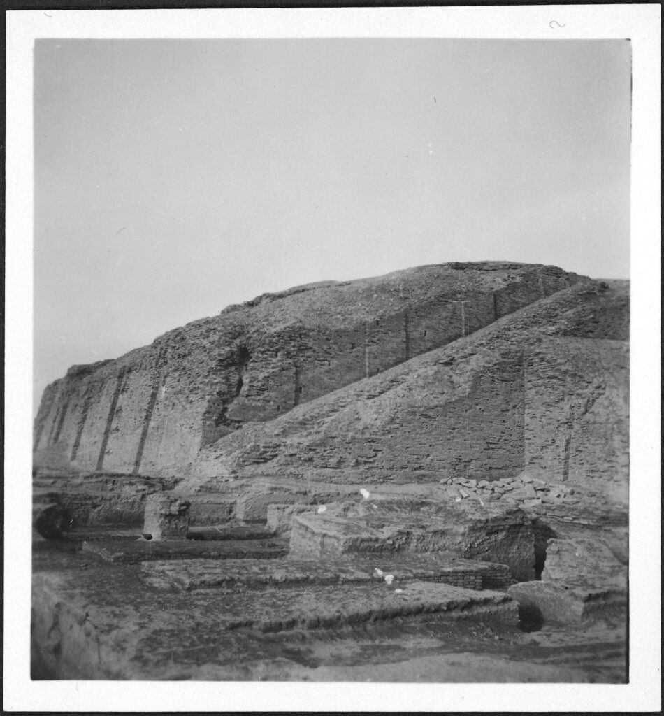 Black-and-white photograph of the eroded ziggurat mound at Uruk taken in the 1930s