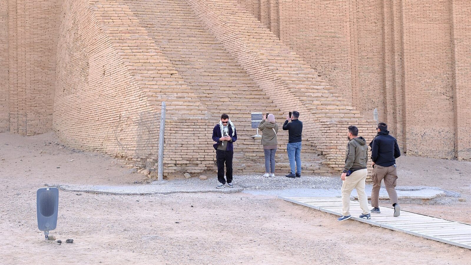 Visitors at the fenced foot of the Ziggurat of Ur's great staircase near Nasiriyah